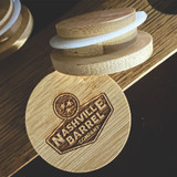 Wholesale engraved Glencairn Barrel Cap customized with Nashville Barrel Company logo on a wood background