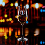 Wholesale engraved Stolzle Tasting Glass customized with Strawberry Thief logo on a bokeh background