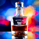 Wholesale engraved Aeneas Whiskey Decanter customized with Wyoming Whiskey logo on a bokeh background