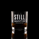 Wholesale engraved 8.5 oz. Stolzle New York Bar Rocks Glass customized with Still Austin Whiskey logo on a black background