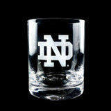 Wholesale engraved 14.25 oz. Stolzle New York Rocks Glass customized with Notre Dame logo on a black background