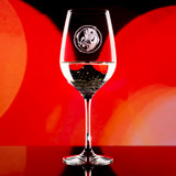 Wholesale engraved 16.75 oz. Stolzle Copa Vino Wine Glass customized with Matts Casbah logo on a bokeh background