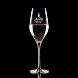 Wholesale engraved 9 oz. Stolzle Exquisit Champagne Flute Glass customized with Stanley Chocolate Factory logo on a black background