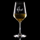 Wholesale engraved Stolzle 16.5 oz. Revolution Wine Glass customized with Haak Wines logo on a black background