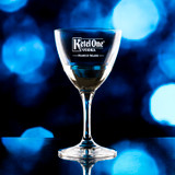 Wholesale engraved 5.75 oz. Stolzle Nick & Nora Glass customized with Ketel One logo on a bokeh background