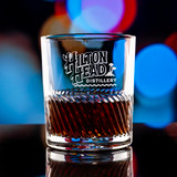 Wholesale engraved 11.5 oz. Riptide Rocks Glass customized with Hilton Head Distillery logo on a bokeh background
