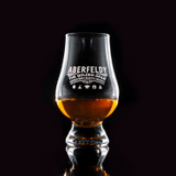 Wholesale engraved Glencairn Whisky Glass customized with Aberfeldy logo on a black background