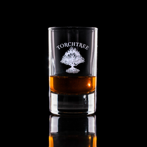 Wholesale engraved 3.25 oz. Islande Shot Glass customized with Torch Tree Bourbon logo on a black background