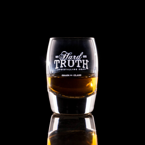 Wholesale engraved 2.5 oz. Urban Bar Barrel Dram Glass customized with Hard Truth Distillers logo on a black background