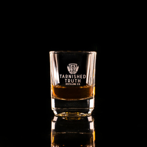 Wholesale engraved 2 oz. Small Batch Shot Glass customized Tarnished Truth Distillers logo on a black background