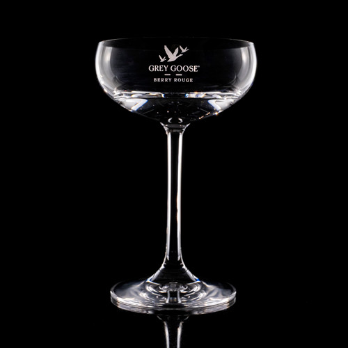 Wholesale engraved 7.75 oz. Stolzle Coupe Glass customized with Grey Goose logo on a black background