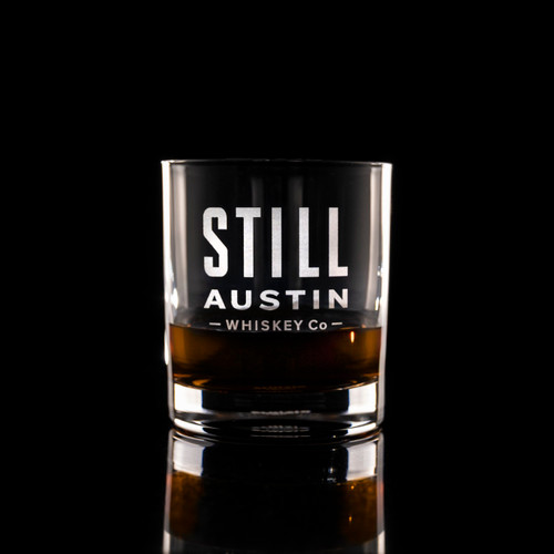 Wholesale engraved 8.5 oz. Stolzle New York Bar Rocks Glass customized with Still Austin Whiskey logo on a black background