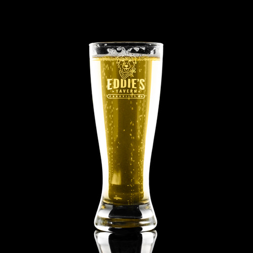Wholesale engraved 12 oz. Grand Pilsner Glass customized with Eddies Tavern logo on a black background