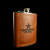 Wholesale engraved 8 oz. Rustic Cognac Leather Flask customized with Garrison Bros Distillery logo on a black background