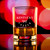 Wholesale engraved 14.25 oz. Stolzle New York Rocks Glass customized with The Kentucky Castle logo on a bokeh background