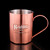 Wholesale engraved Copper Camp Mugs customized with Ketel One logo on a black background