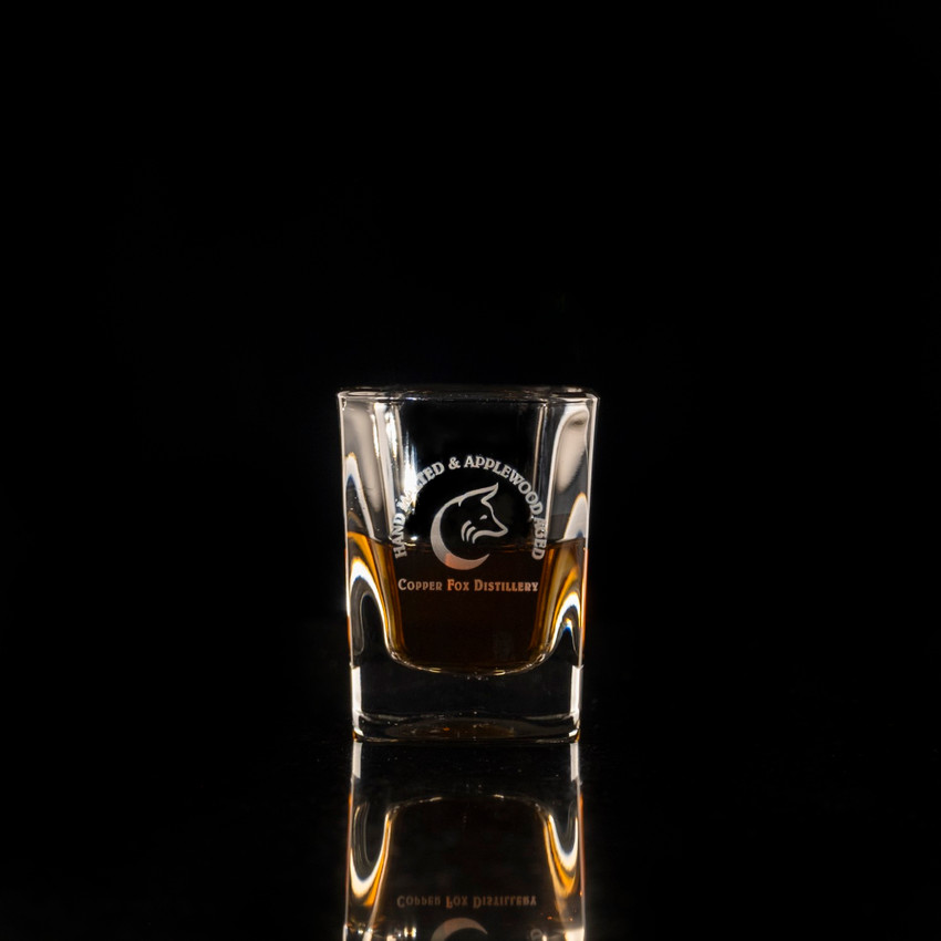 Wholesale engraved 2 oz. Prism Shot Glass customized with Copper Fox Distillers logo on a black background