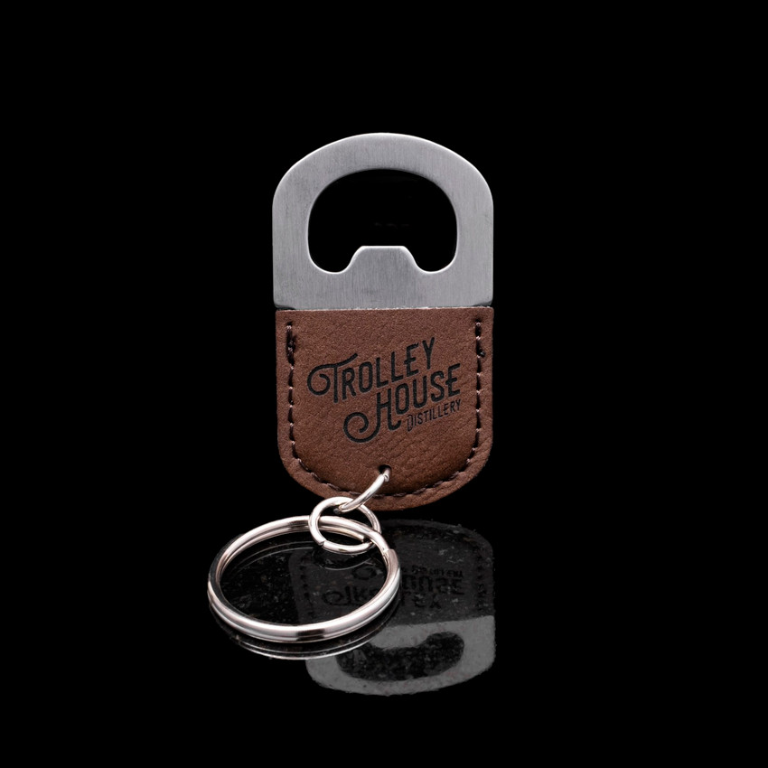 Wholesale engraved Rum Mini Opener customized with Trolley House logo on a black background