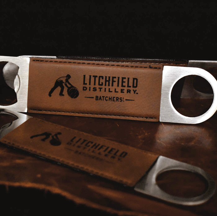 Wholesale engraved Rum Bottle Opener customized with Litchfield Distilling logo on a black background