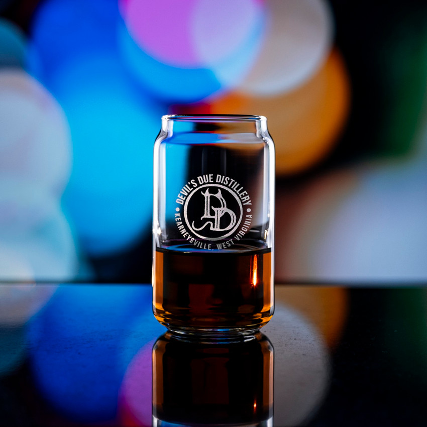 Wholesale engraved 5 oz. Short Can Taster Glass customized with Devils Due Distilling logo on a bokeh background