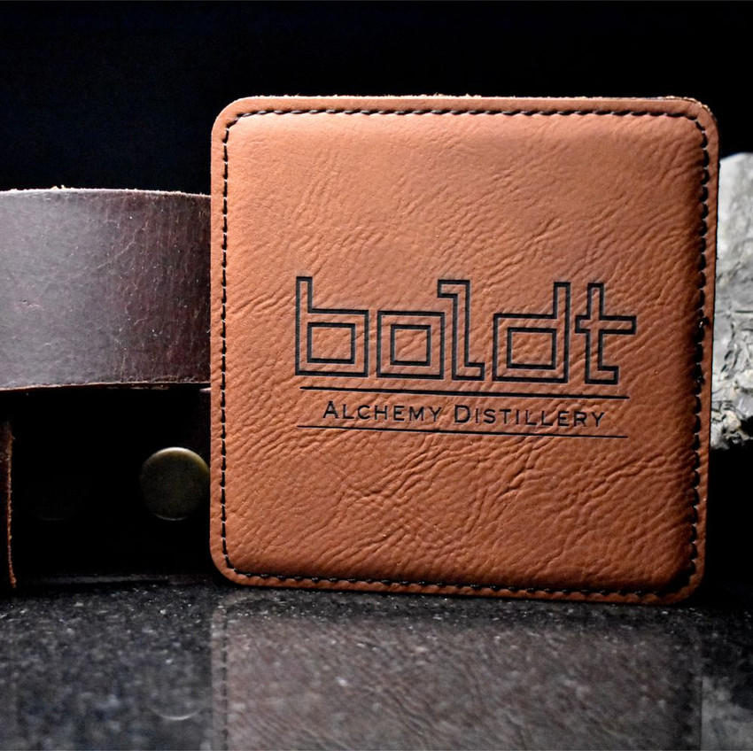 Wholesale engraved Cognac Brown Square Coaster customized with Alchemy Distillery logo