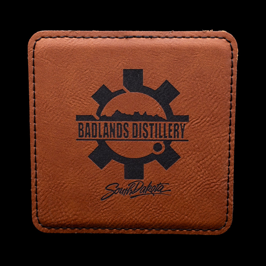 Wholesale engraved Cognac Brown Square Coaster customized with Badlands Distillery logo on a black background
