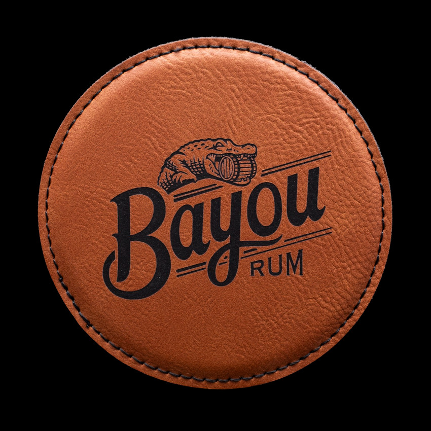 Wholesale engraved Cognac Round Coaster customized with Bayou Rum logo on a black background