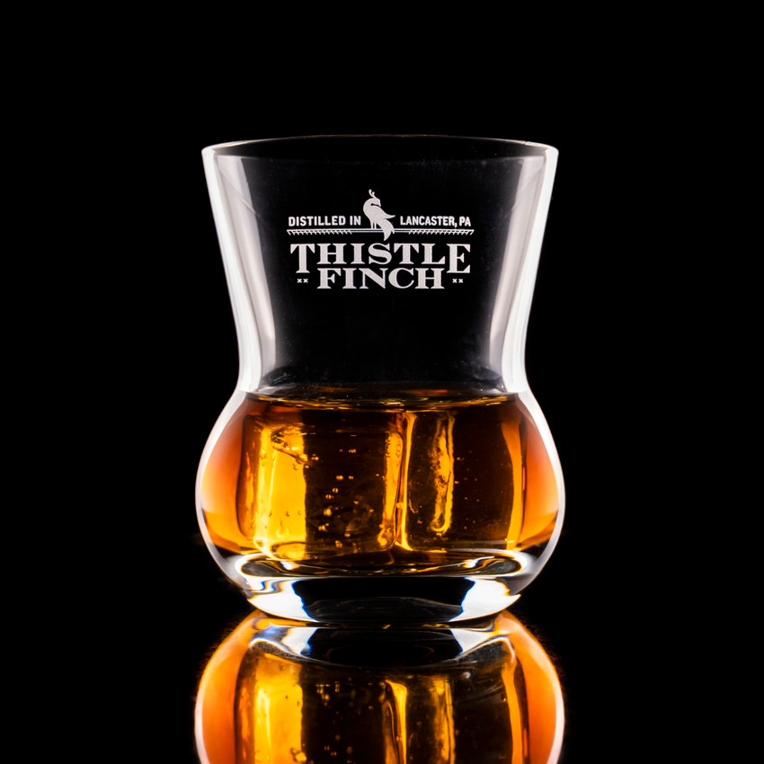 Wholesale engraved 9 oz. Urban Bar Thistle Old Fashioned Glass customized with Thistle Finch Distilling logo on a black background