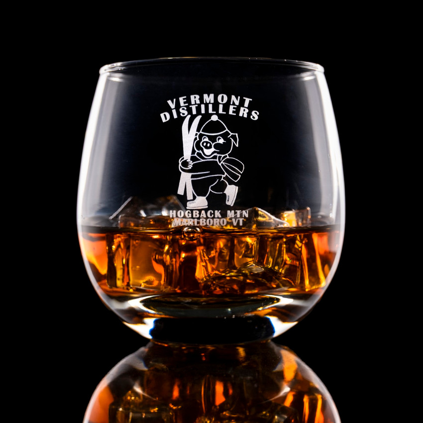 Wholesale engraved 15 oz. Hogs Head Rocks Glass customized with Vermont Distillers logo on a black background