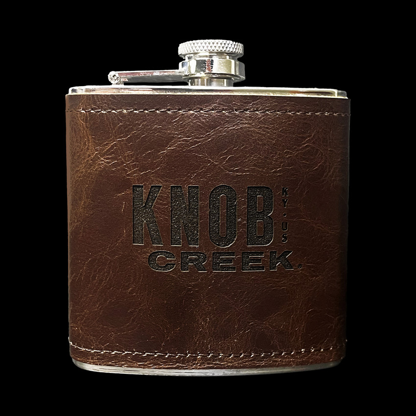 Wholesale engraved 6 oz. Wick·ed Rum Leather Flask customized with Knob Creek logo on a black background