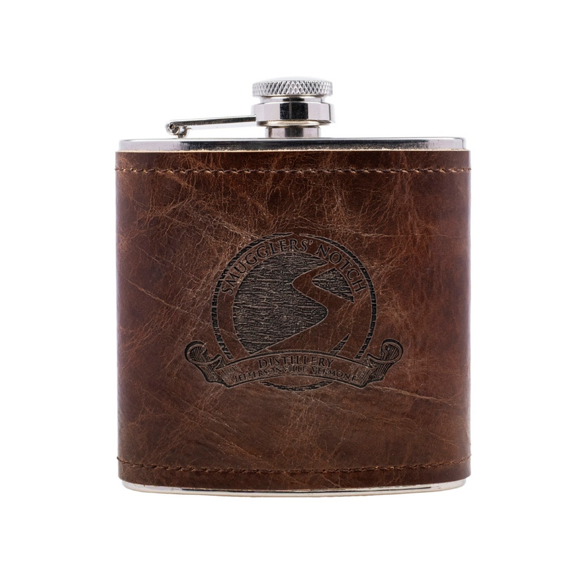 Wholesale engraved 6 oz. Wick·ed Rum Leather Flask customized with Smugglers Notch logo on a white background