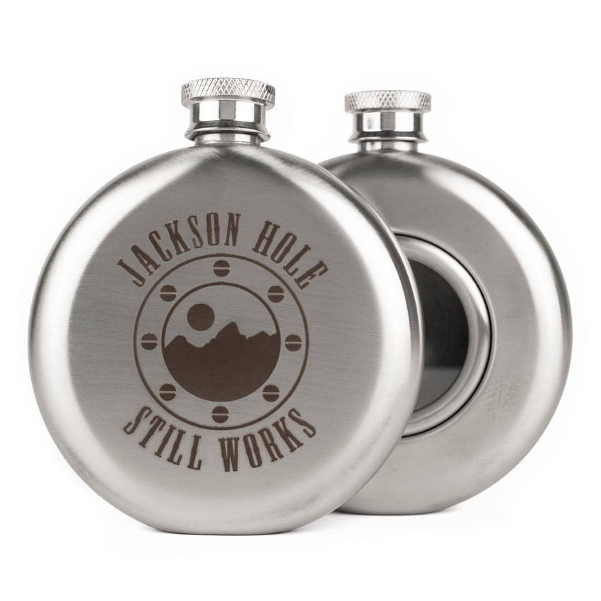 Wholesale engraved 5 oz. Port Hole Flask customized with Jackson Hole Still Works logo on a white background