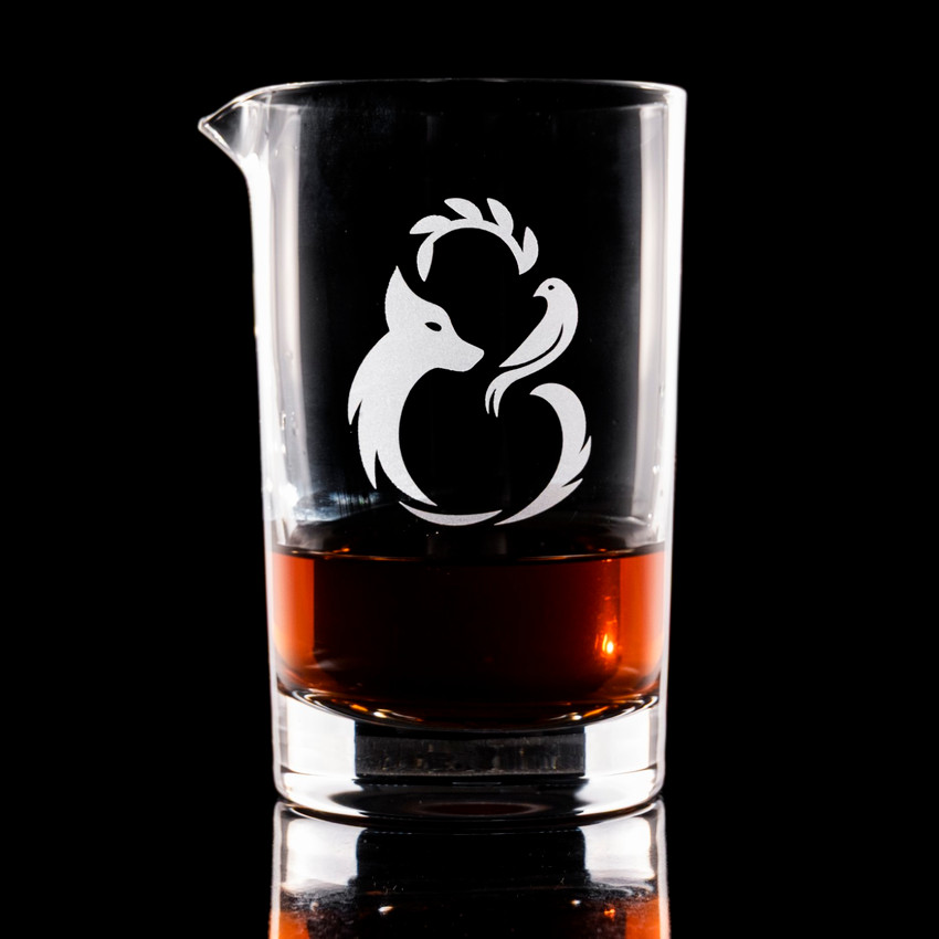 Wholesale engraved Cristallo Mixing Glass customized with Fierce & Kind Logo on a black background