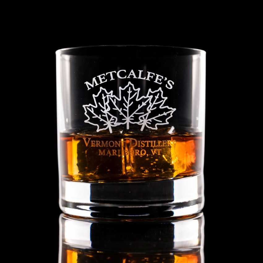 Wholesale engraved 10.75 oz. Stolzle New York Bar Rocks customized with Metcalfe's Distillers logo on a black background