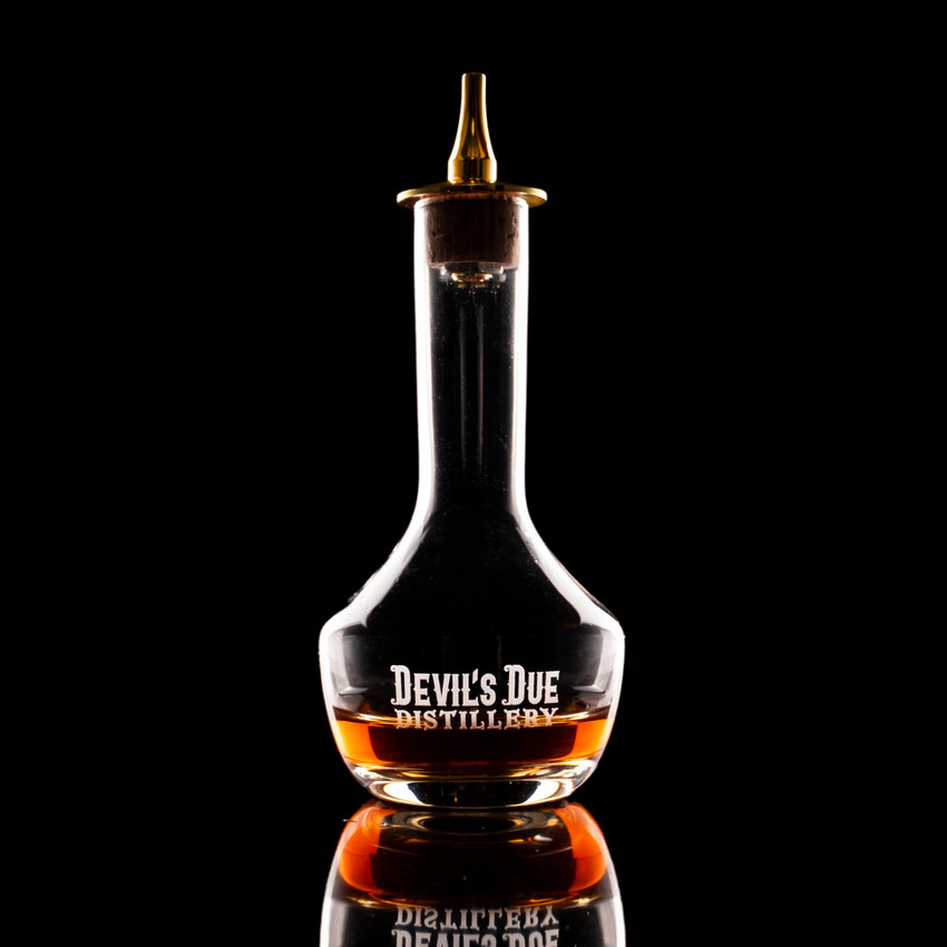 Wholesale engraved 3 oz. Gold Bitters Bottle customized with Devils Due Distilling logo on a black background