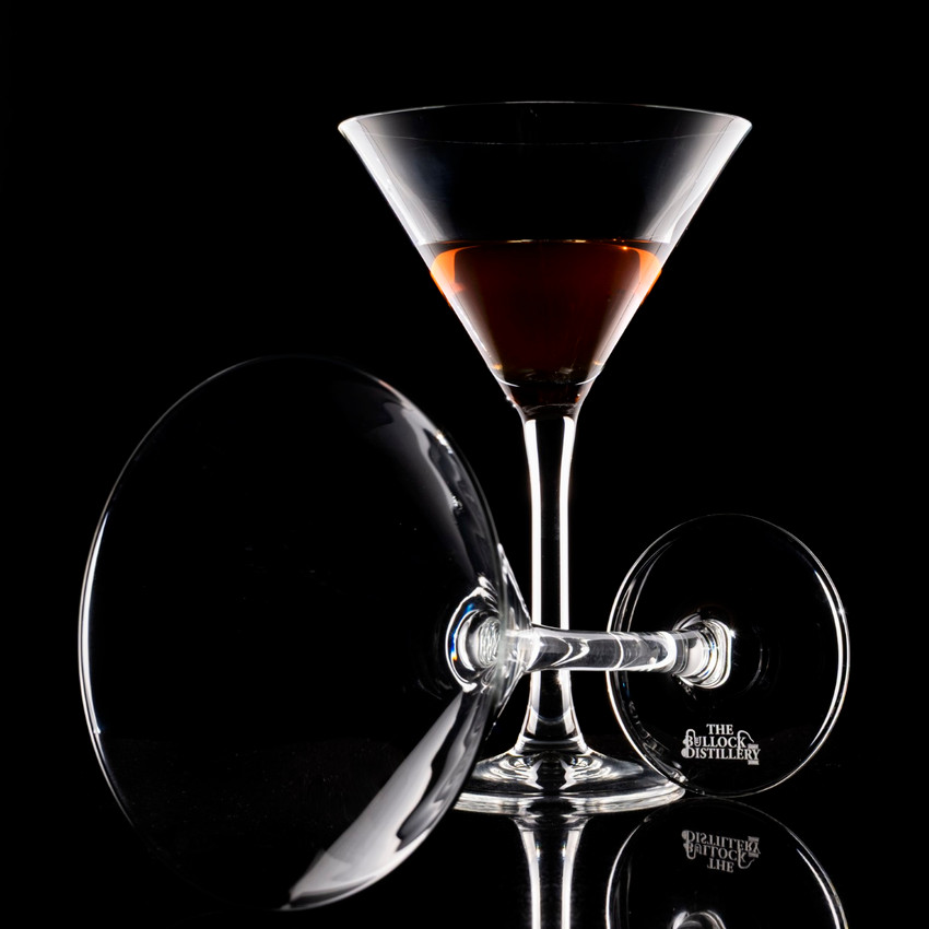 Wholesale engraved 10.5 oz. Classic Martini Glass customized with The Bullock Distillery logo on a black background