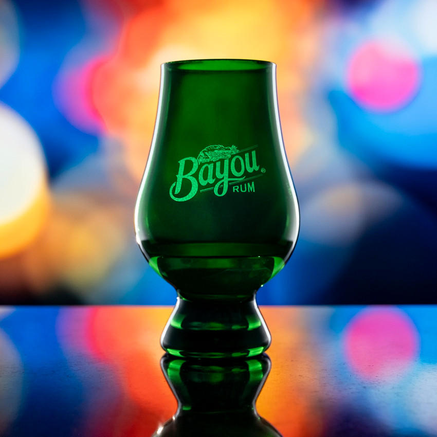 Wholesale engraved Green Glencairn blind tasting glass customized with Eagle Rare Whiskey logo on a Bokeh background