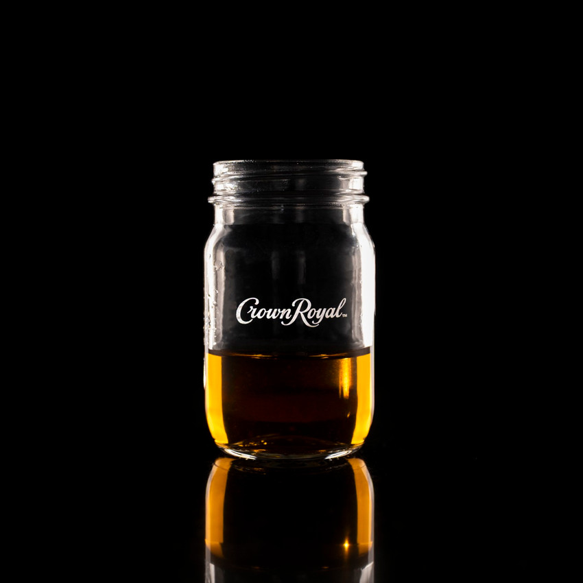Wholesale engraved 4 oz. Mason Mini Jar customized with Crown Royal logo on a black background