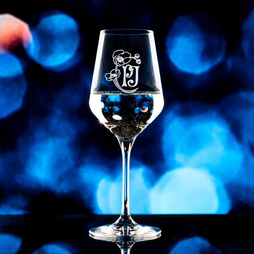 Wholesale engraved 12.75 oz. Revolution Wine Glass customized with PJ Flower logo on a bokeh background