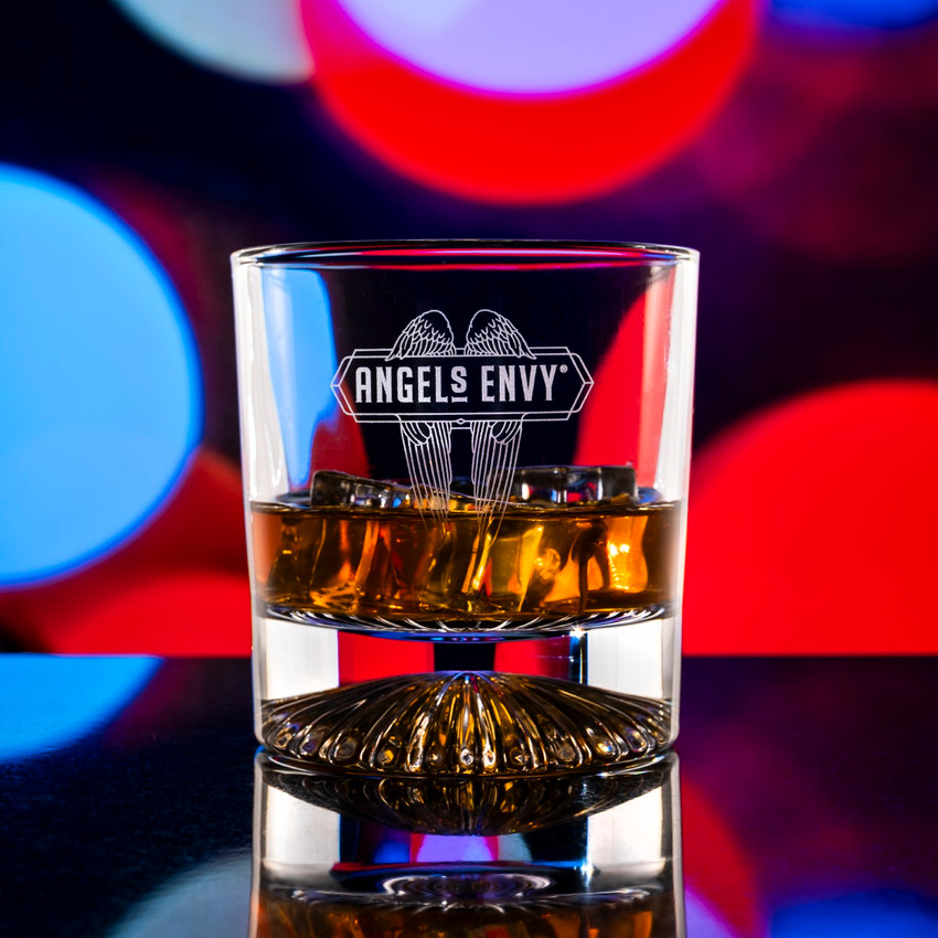 Wholesale engraved 10 oz. Venus Rocks Glass customized with Angels Envy logo on a bokeh background