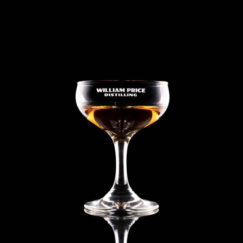 Wholesale engraved 5.5 oz. Mini Coupe customized with William Price Distilling logo on a black background