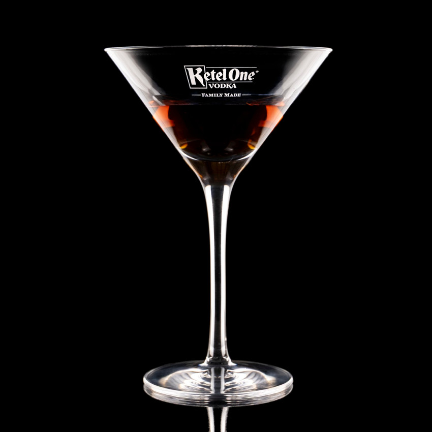 Wholesale engraved 9 oz. New York Martini Glass customized with Ketel One Vodka logo on a black background