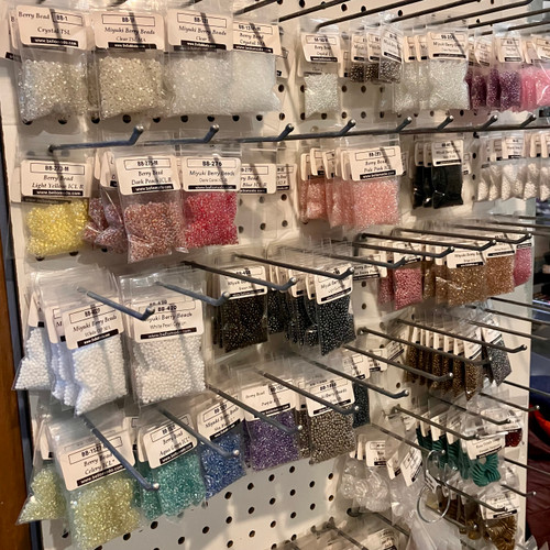 Lot of Berry Beads on pegboard rack