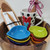 Wooden Gift Bowl Set includes 10 inch wooden bowl, 7 heart dishes in chakra colors, wooden spoon, wooden charcuterie and cheese board