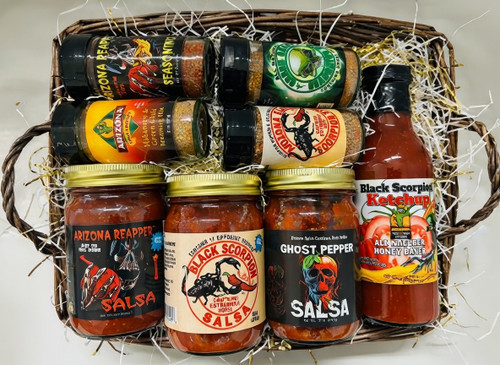 This is a premium spicy gift basket featuring bold, heat-packed products from Arizona-based brands (like Arizona Spice Company and Black Scorpion line). It's shrink-wrapped for gifting/shipping, nestled in a wicker basket with shredded filler