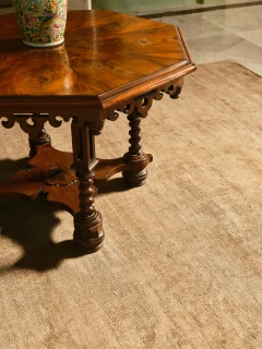 Caliche Silk rug in Olive, styled vignette with an antique side table