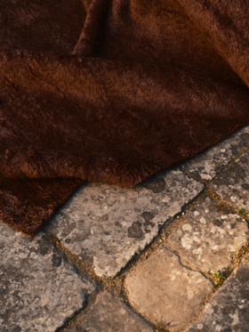 Mohair Shag rug in Carob, corner detail on stone flooring