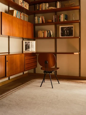 Arc rug in Amber, styled vignette in a wood-paneled library setting