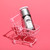 Secret Agent VI serum in a pink miniature shopping cart on pink background.