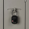 A black TSA lock secured to a grey locker, featuring a combination dial and a small logo.